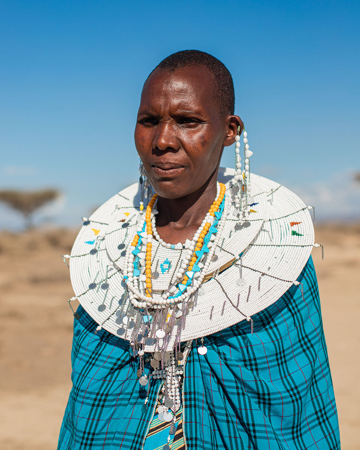 Maasai man wearing maasai shuka fabrics and jewels Tanzania