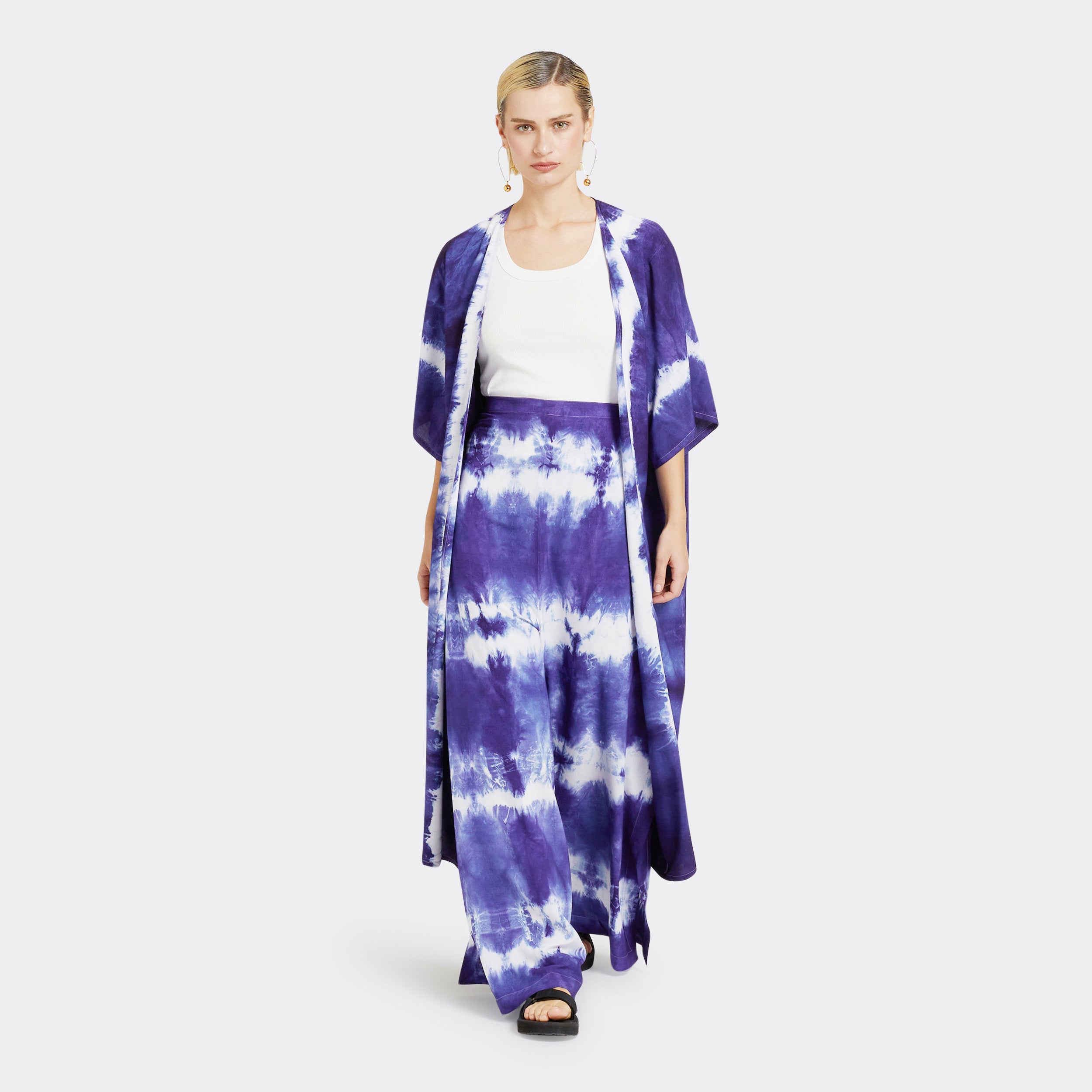 Model wears Wrap Trousers in Tie Dye Soft Blue with a plain white top and a Kimono in Tie Dye Soft Blue.