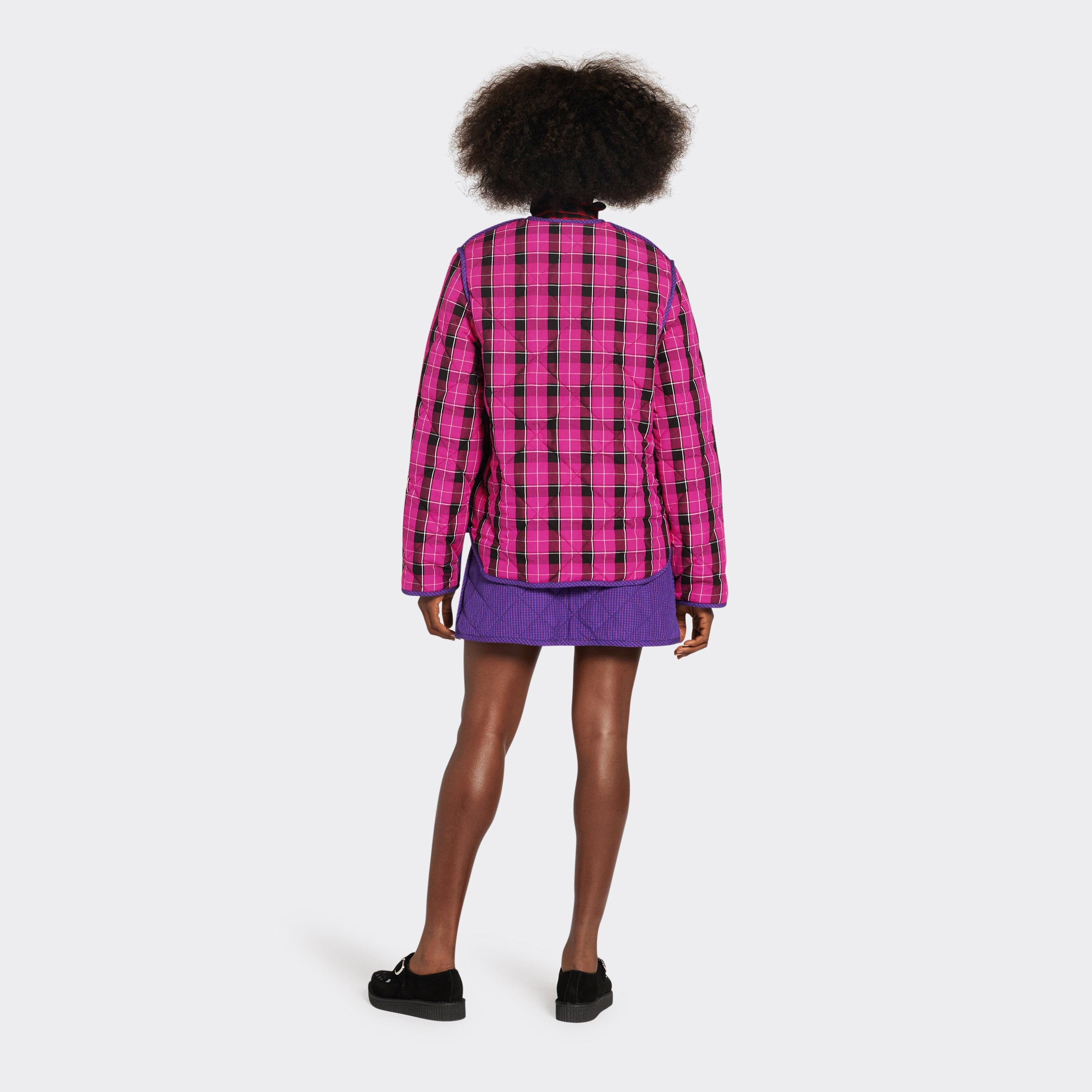 Reversible quilted jacket in pink checked Maasai fabric on model  seen from the back