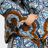 Detail of the pocket of the Reversible quilted jacket in african wax fabrics on model 