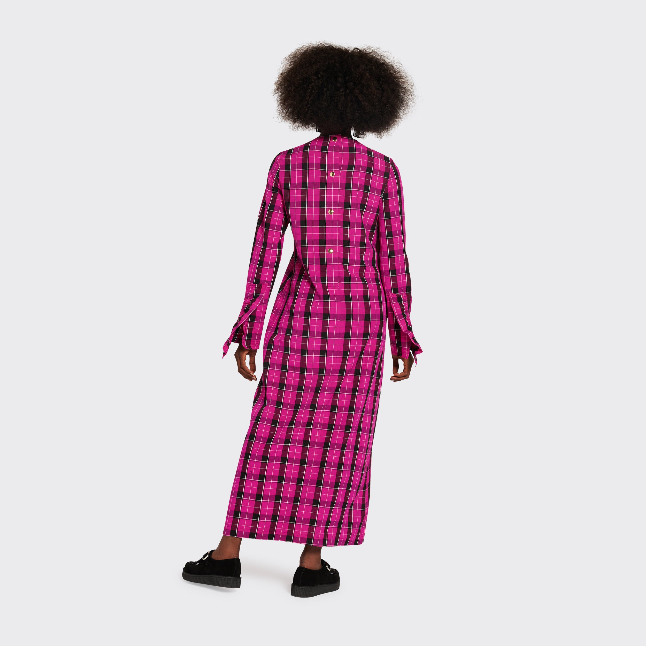 Long pink dress in Maasai fabric with black checks on model seen from the back