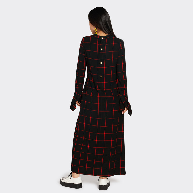 Long black dress in Maasai fabric with red checks on model seen on the back