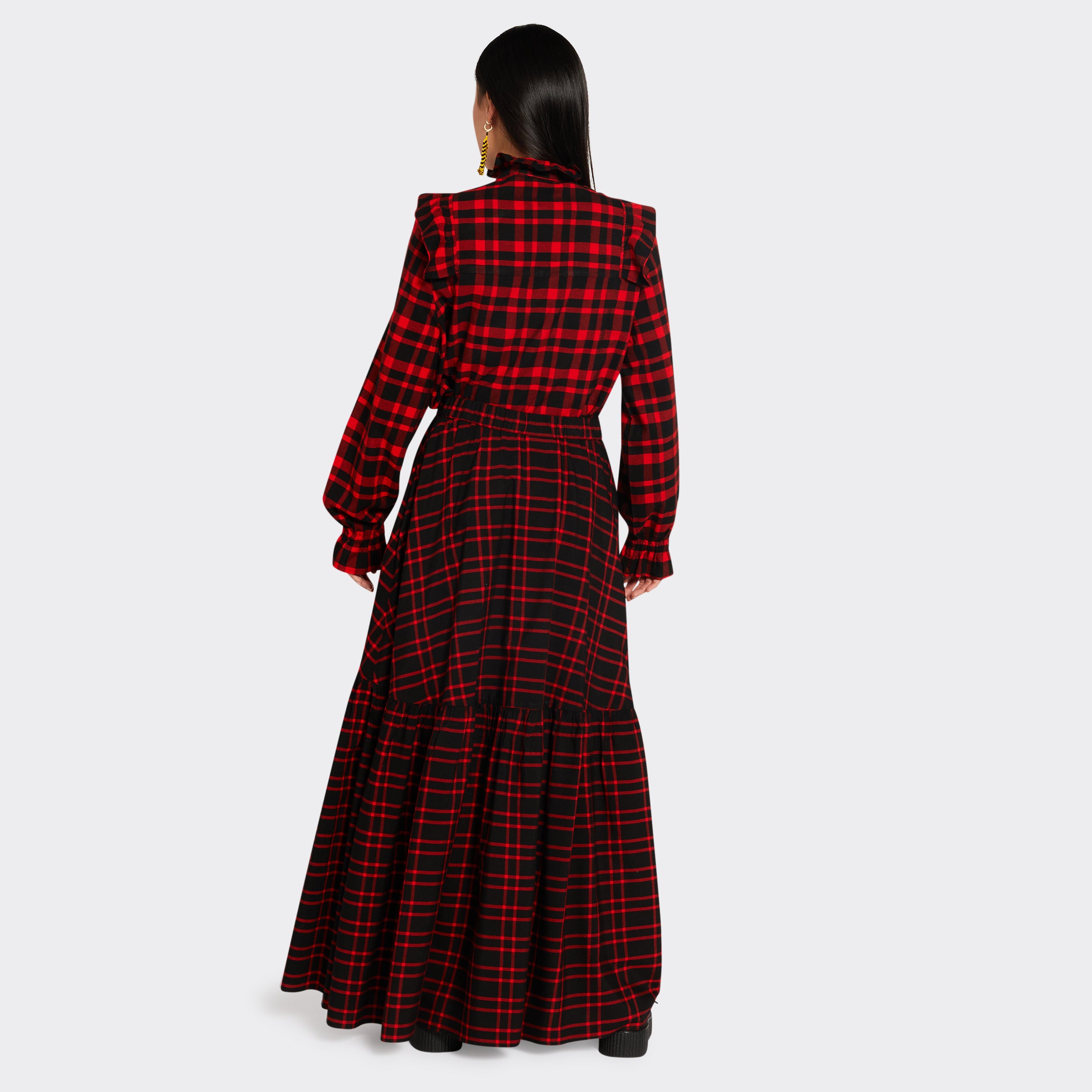 Black maxi skirt in Maasai fabric with red checks on model seen from the back