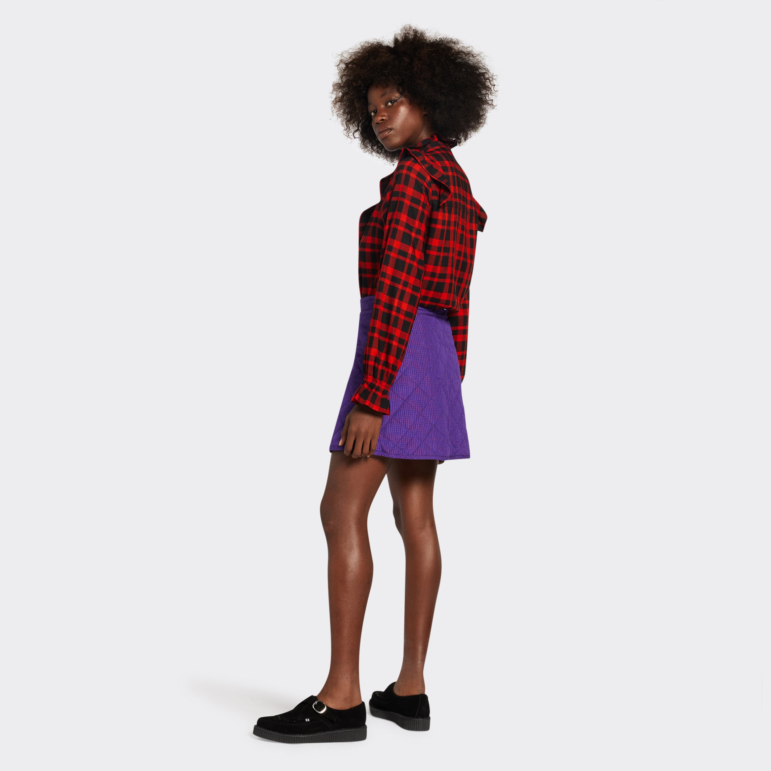reversible padded miniskirt in maasai fabric worn on the purple side with micro checks
