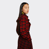 Black shirt with ruffles on the front in maasai fabric with red checks on model