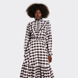 White shirt with ruffles on the front in maasai fabric with black checks on model