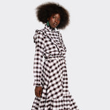 White shirt with ruffles on the front in maasai fabric with black checks on model
