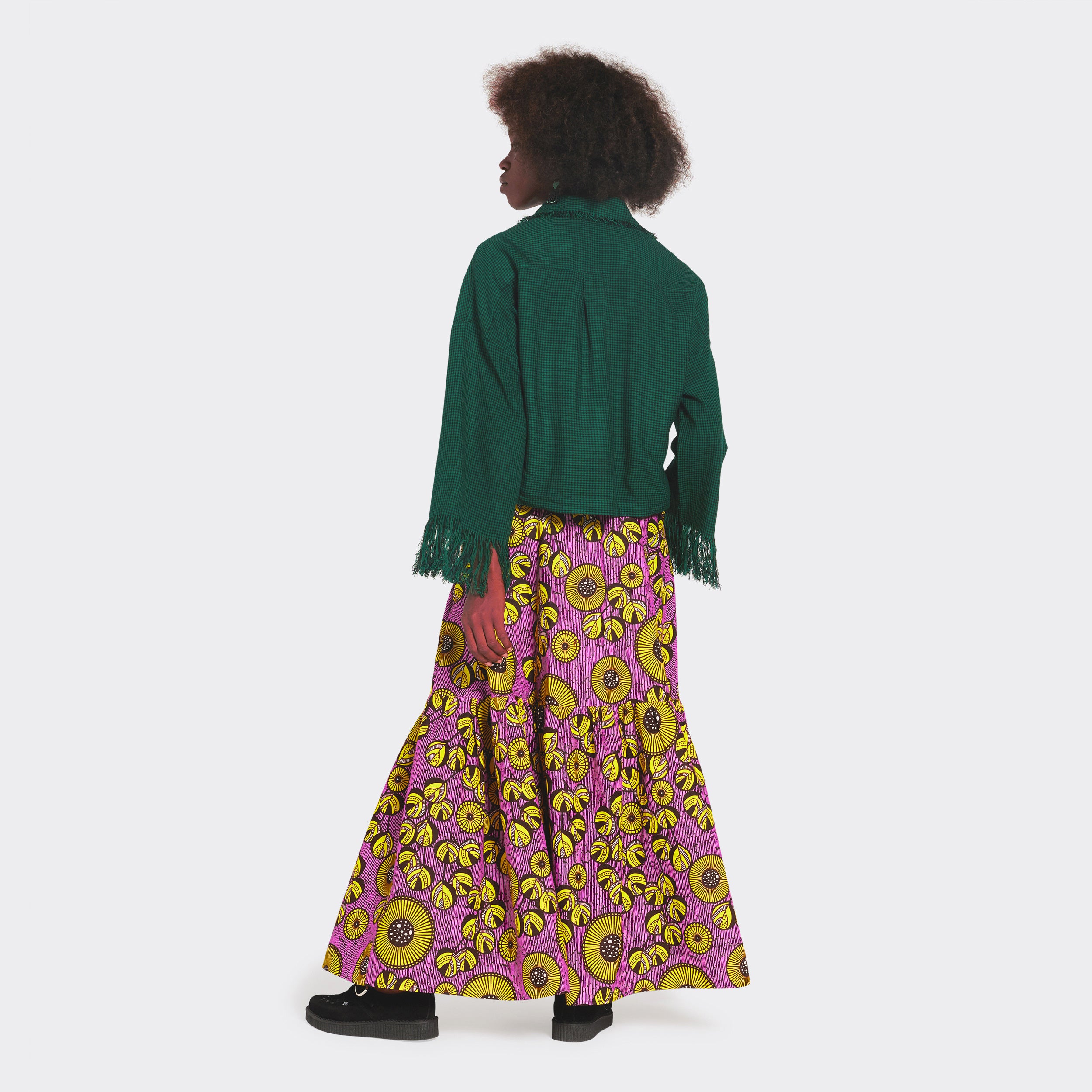 Maxi skirt with lilac flounces with yellow flowers in African wax fabric on the model