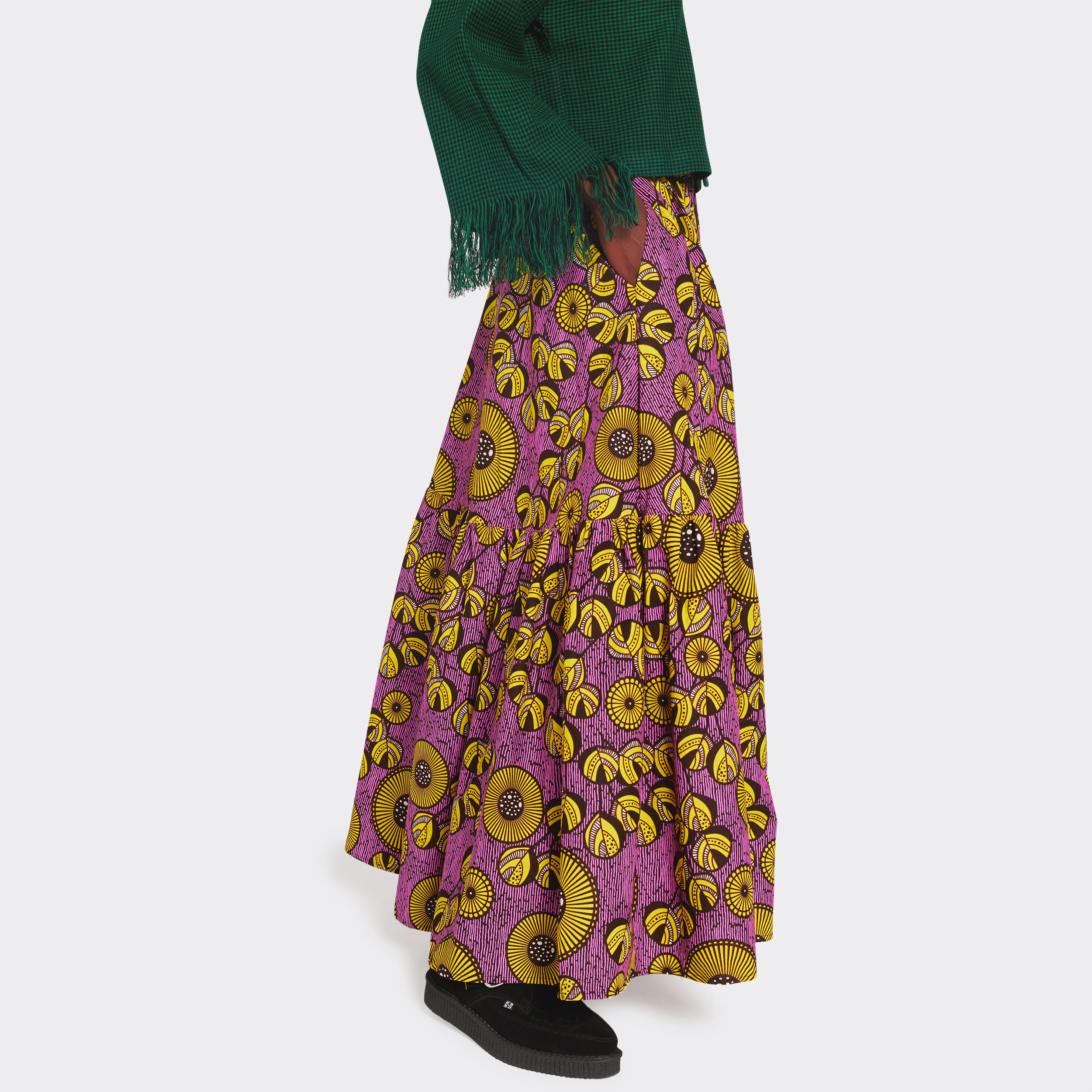 Maxi skirt with lilac flounces with yellow flowers in African wax fabric on the model
