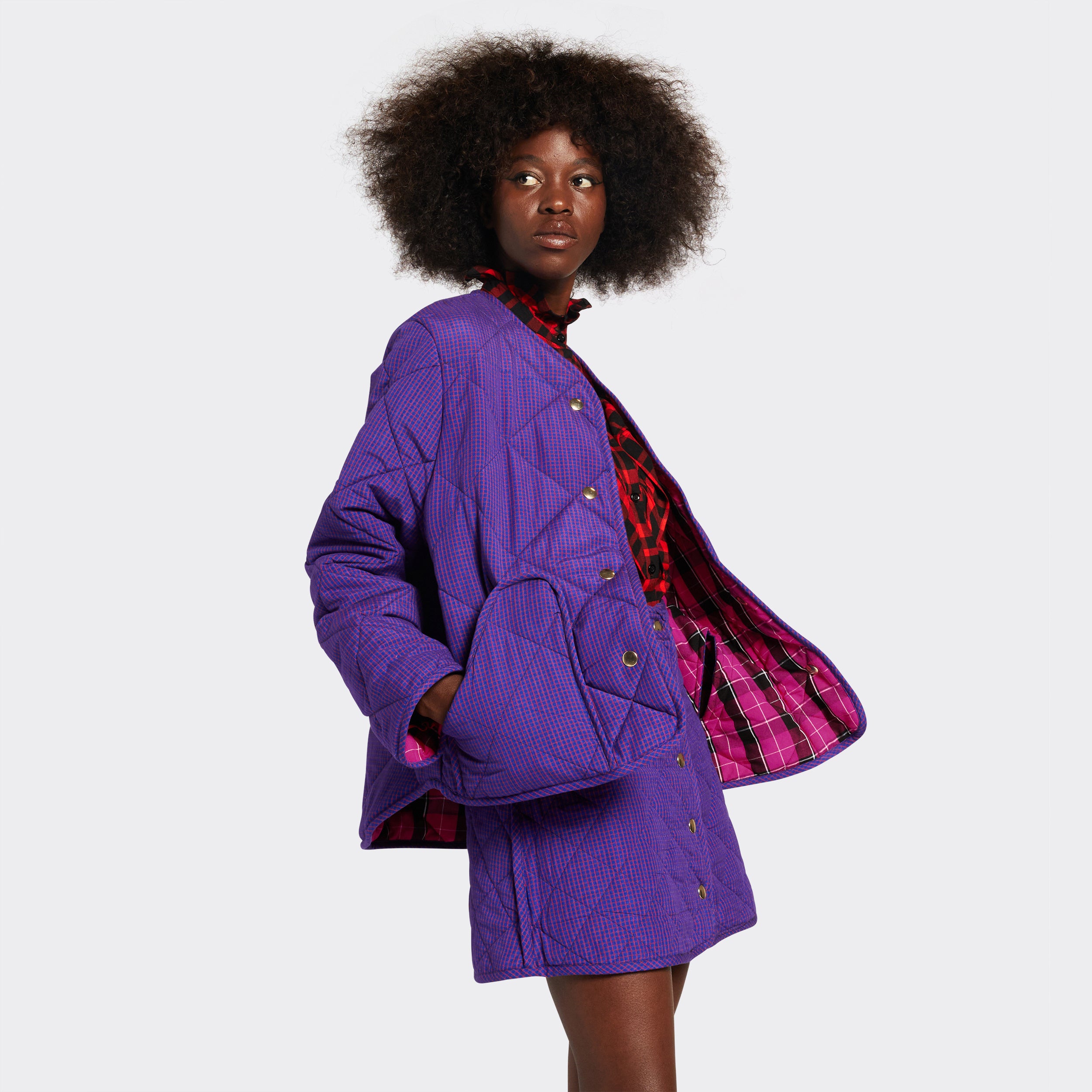 Reversible quilted jacket in pink checked Maasai fabric on model , on the purple side