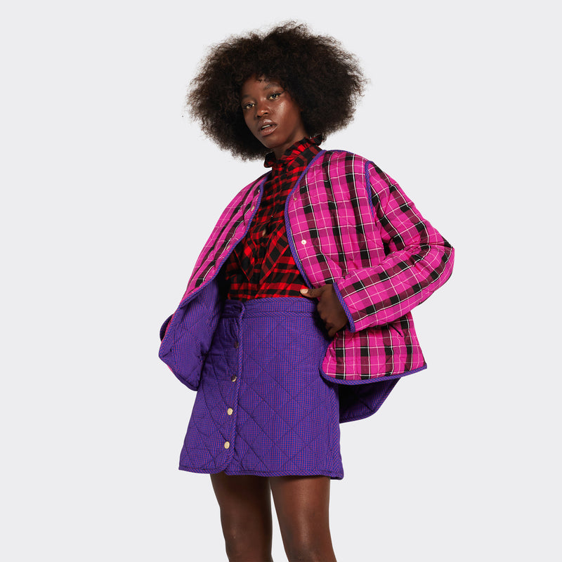 Reversible quilted jacket in pink checked Maasai fabric on model 