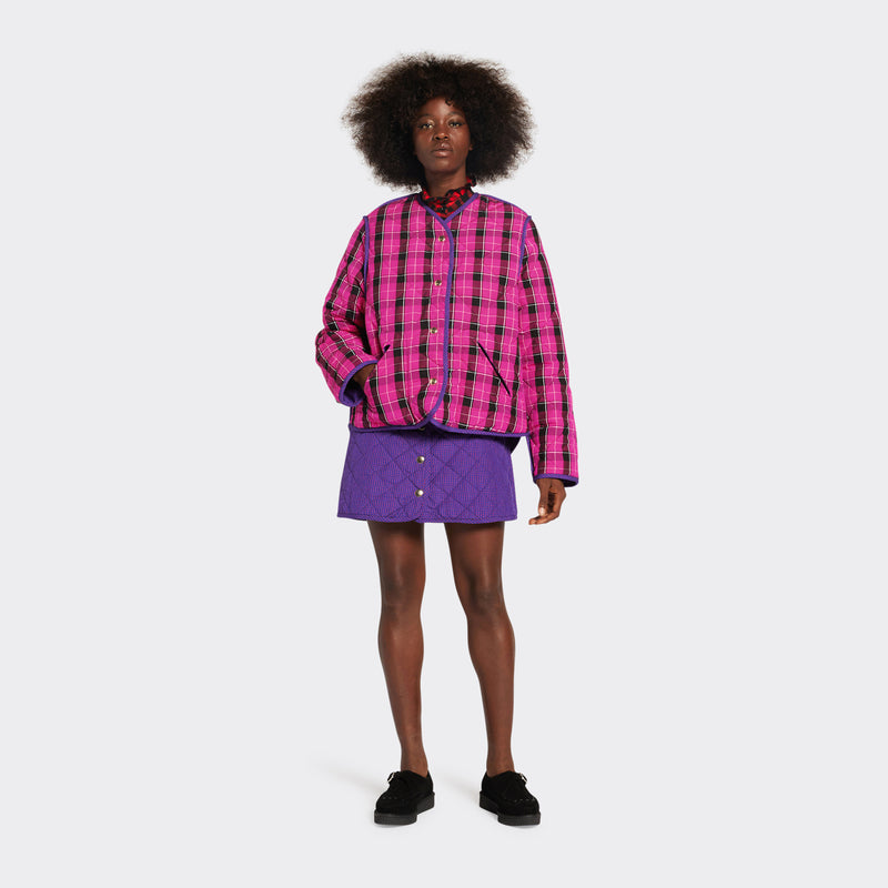 Reversible quilted jacket in pink checked Maasai fabric on model 