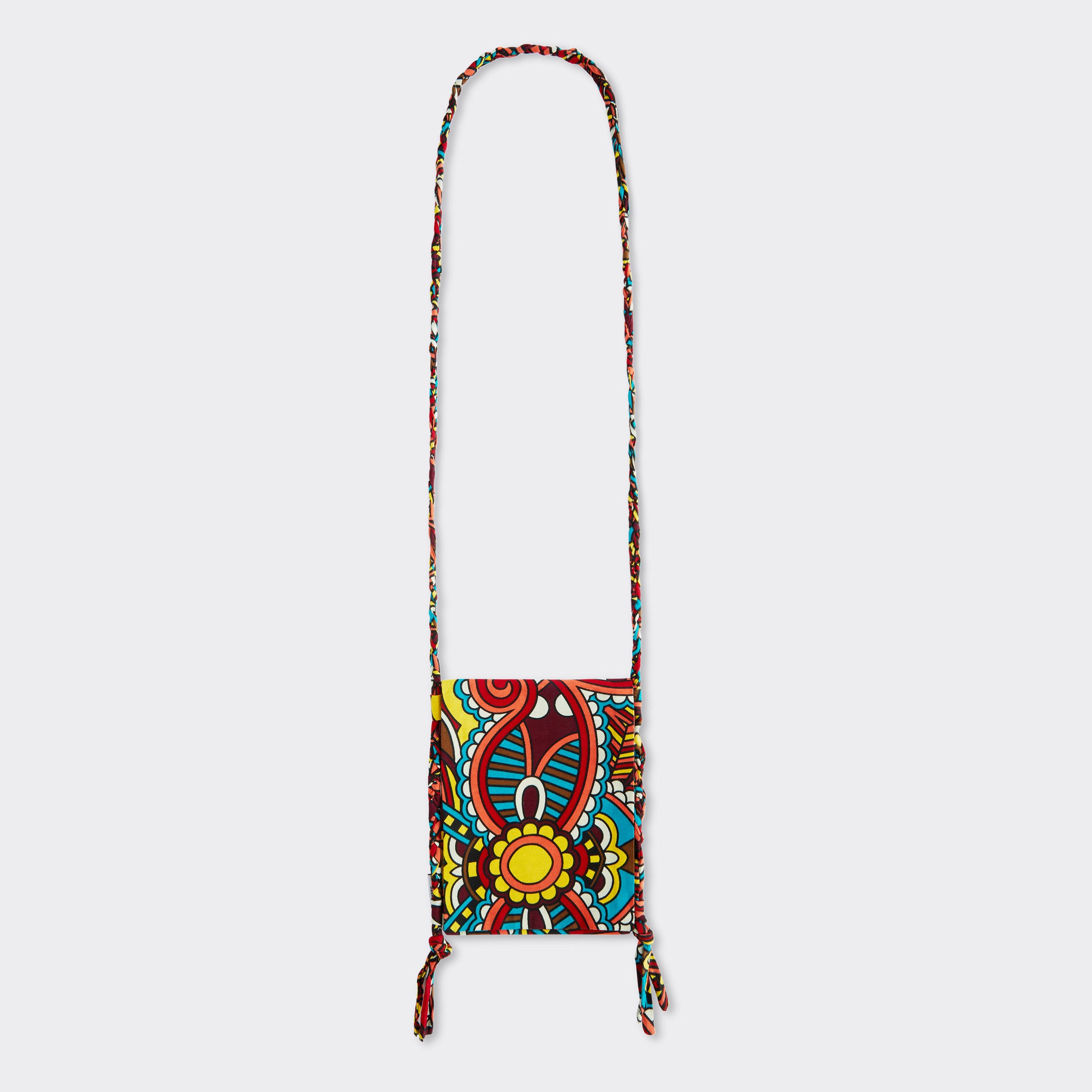 Still life: Crossbody Mini Bag in Wax African Dream with colors red, blue, and yellow