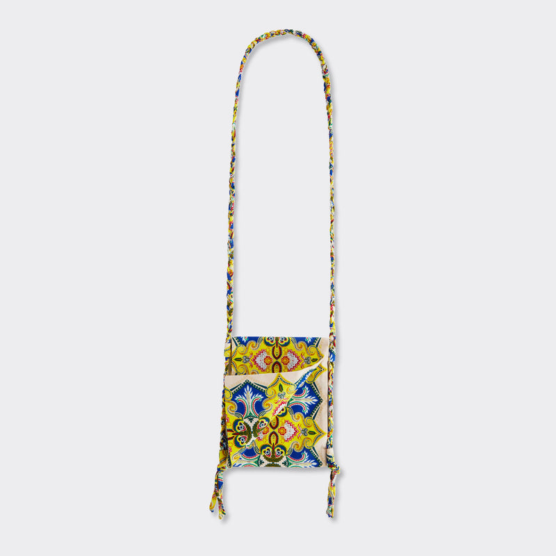 Still life: Crossbody Mini Bag in Wax Magic Mosaic with colors yellow and blue. 