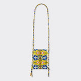 Still life: Crossbody Mini Bag in Wax Magic Mosaic with colors yellow and blue. 