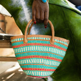 Editorial photo: Model holds Mini Shopping Bag in Sisal Turquoise.