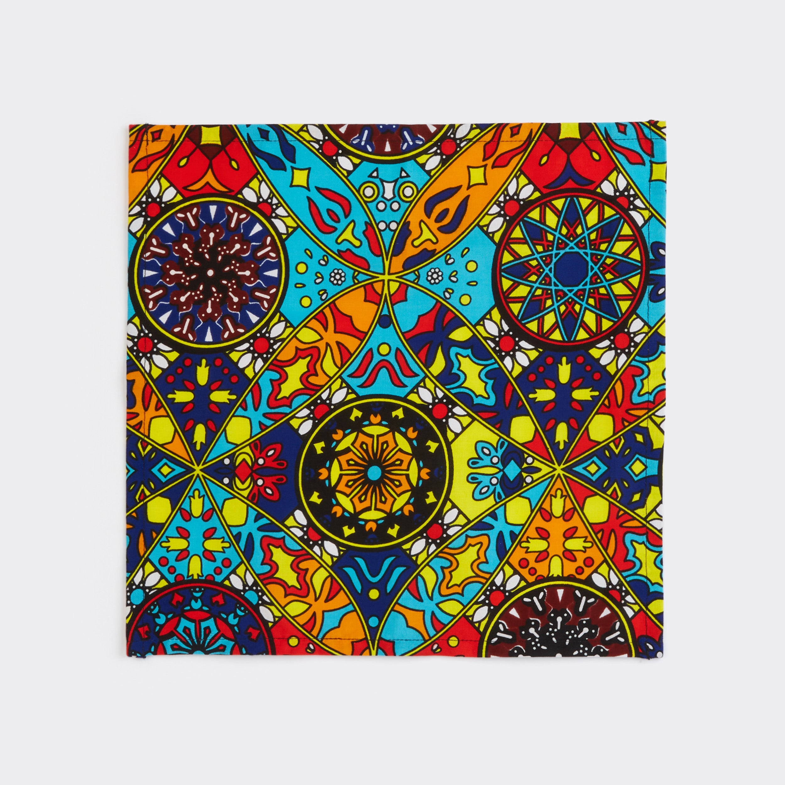 Still life: Pair of Napkins in Wax Circus Fantasy Circus Fantasy with colors blue, yellow, and orange.