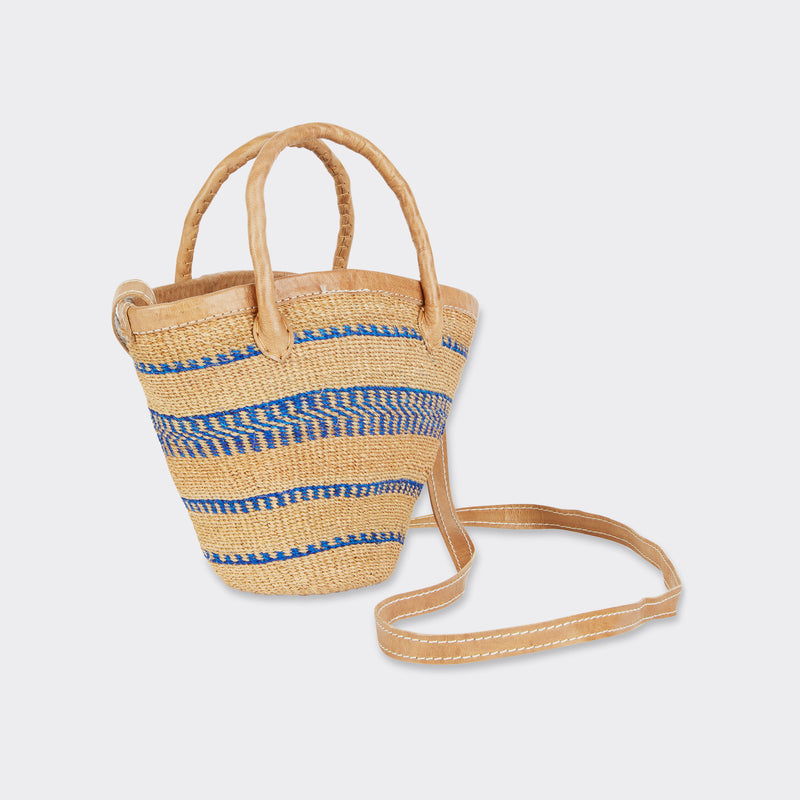 Still life: Mini Shopping Bag in Sisal Blue Stripes with the colors blue and brown with the shoulder strap visible.
