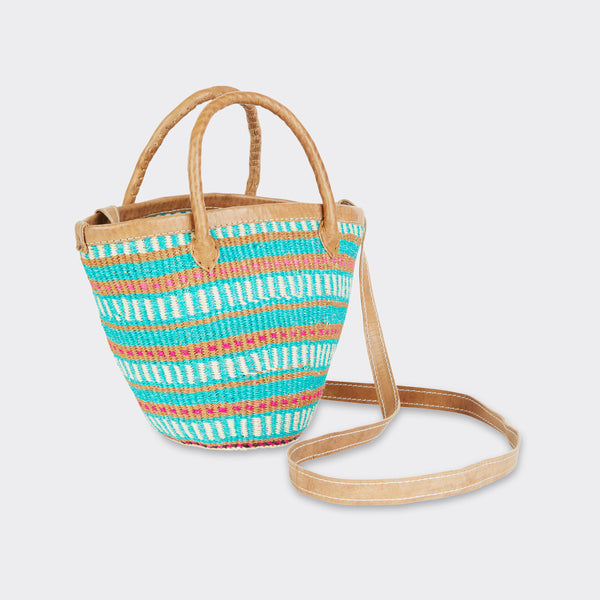 Still life: Mini Shopping Bag in Sisal Turquoise with colors turquoise and brown, with the long shoulder strap is visible.