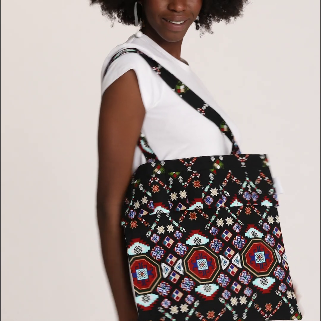 Video: Model holds all different color variants of the Tote Bag with Rouche in Wax, including African Dream, Dreamcatcher, Candy Leaves, Sun Labyrinth, and Almasi Game.