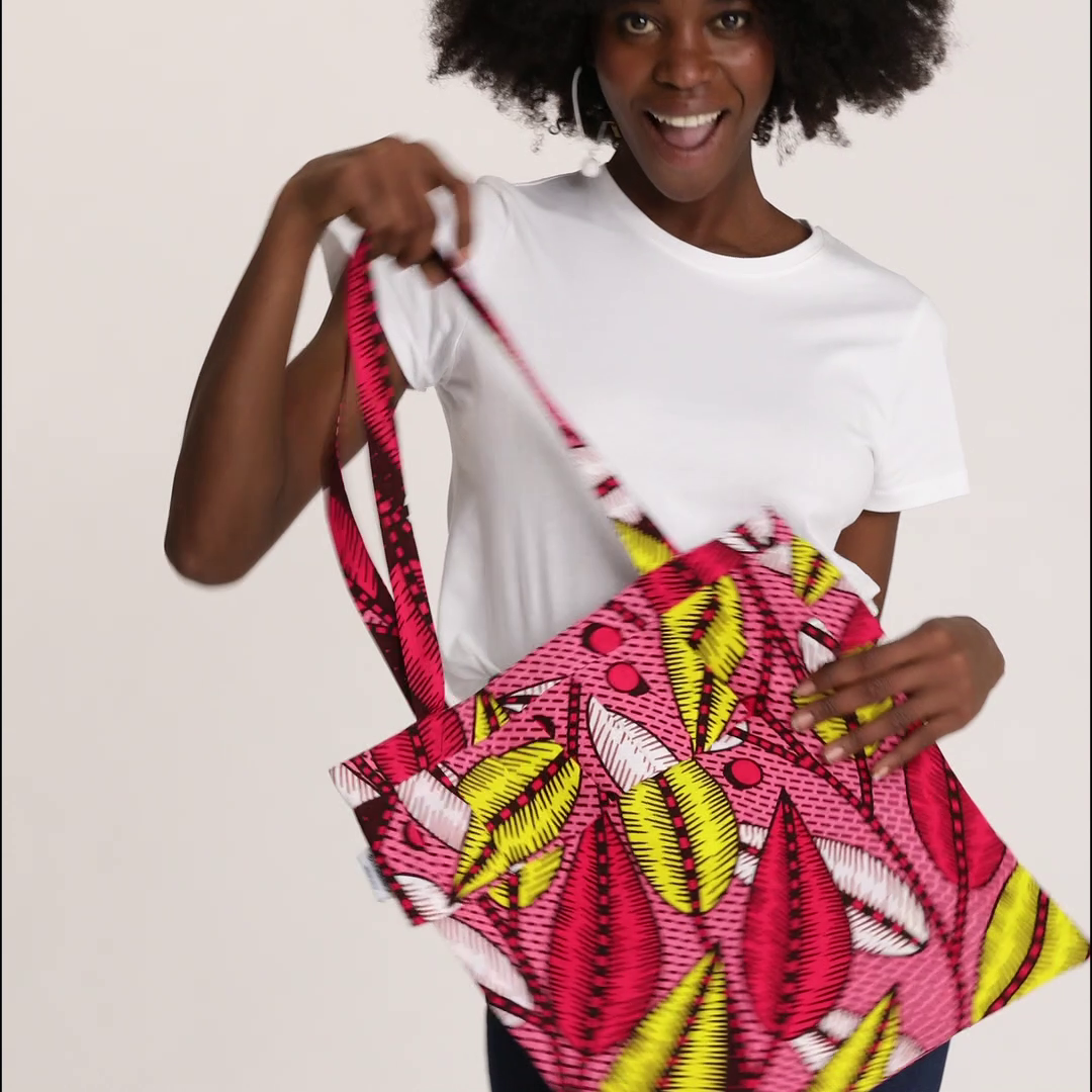 Video: Model holds all different color variants of the Tote Bag with Rouche in Wax, including African Dream, Dreamcatcher, Candy Leaves, Sun Labyrinth, and Almasi Game.