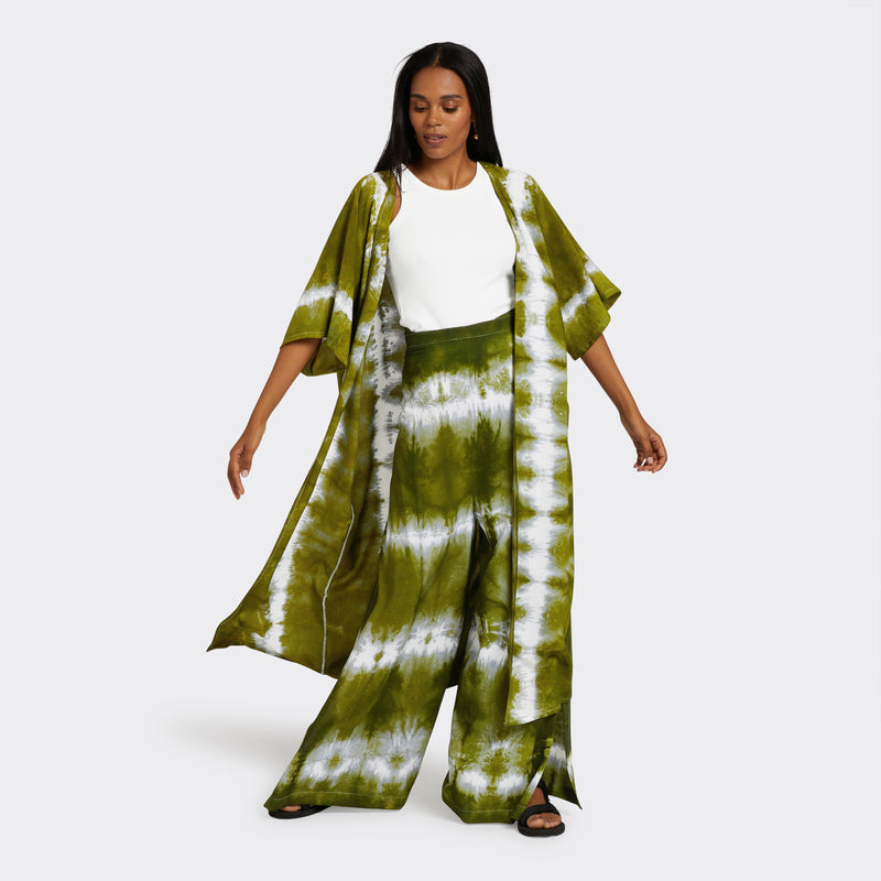 Model wears a Kimono in Tie Dye Intense green with a white shirt underneath. Along with the Wrap Trousers in Tie Dye Intense Green.