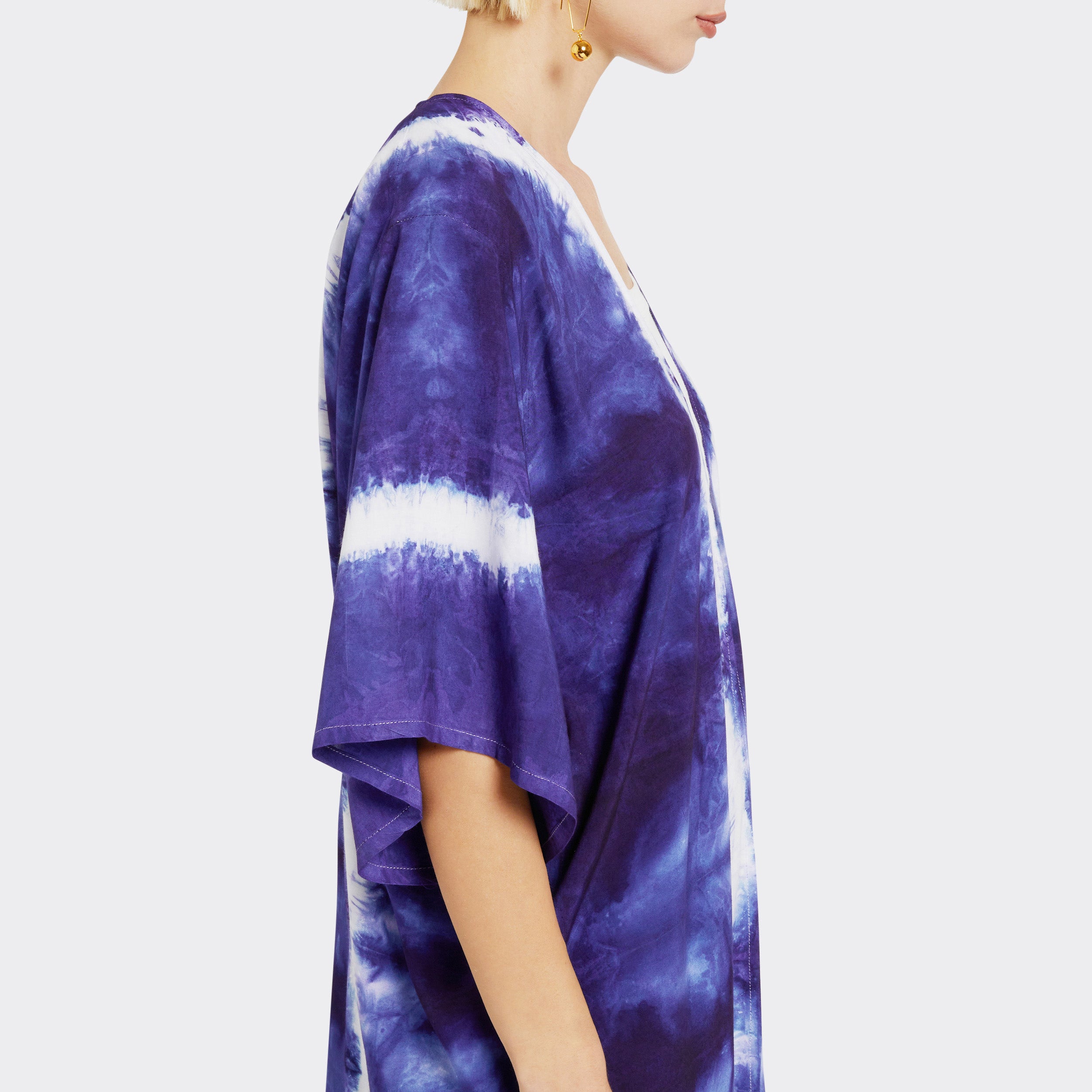 Model wears a Kimono in Tie Dye Soft Blue where you can see the sleeve detail, with a white shirt underneath.
