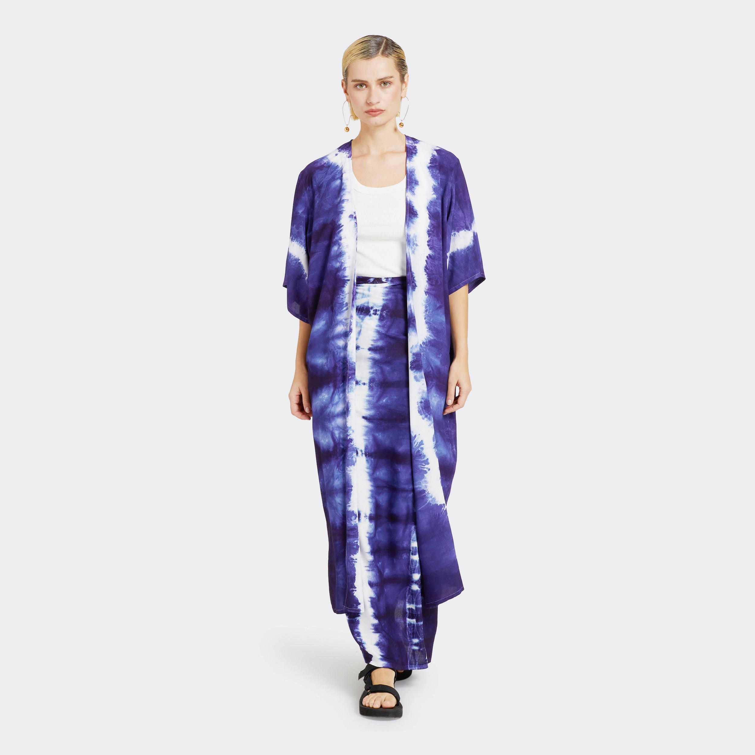 Model wears a Kimono in Tie Dye Soft Blue with a white shirt underneath. Along with the Wrap Trousers in Tie Dye Soft Blue.