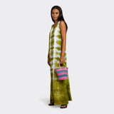 Model is holding the Mini Shopping Bag in Sisal Pink & Blue with the colors pink and blue. She is wearing a Tie Dye Long Dress in Intense Green which has the colors green and white.
