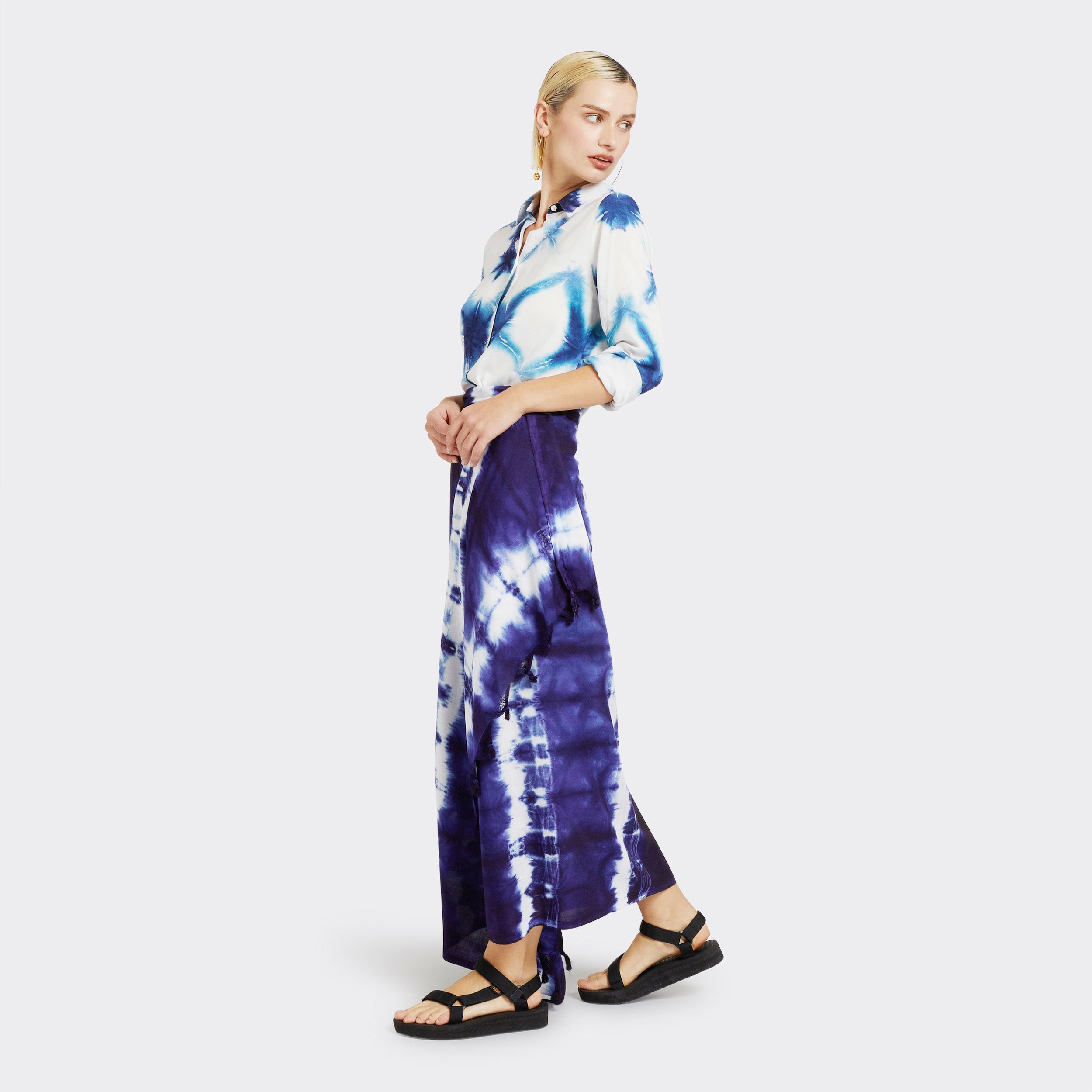 Model wears a Pareo in Tie Dye Soft Blue as a skirt with the Shirt in Tie Dye White and Blue.
