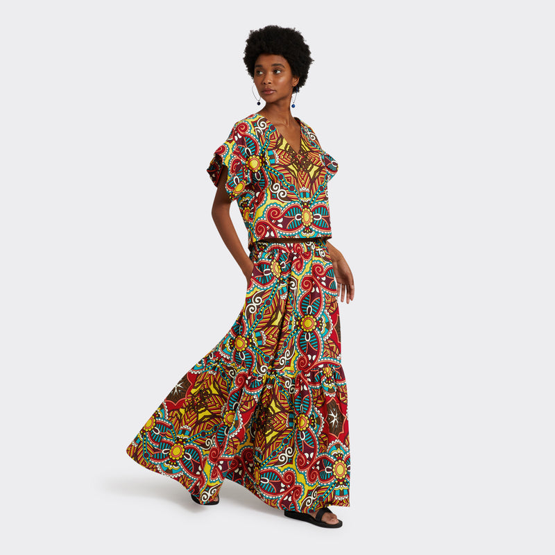 Model wears Flounced Maxi Skirt in Wax African Dream with the colors yellow, blue and red. She is wearing the matching Ruffled Top in Wax African Dream with the colors yellow, blue and red for a total look.