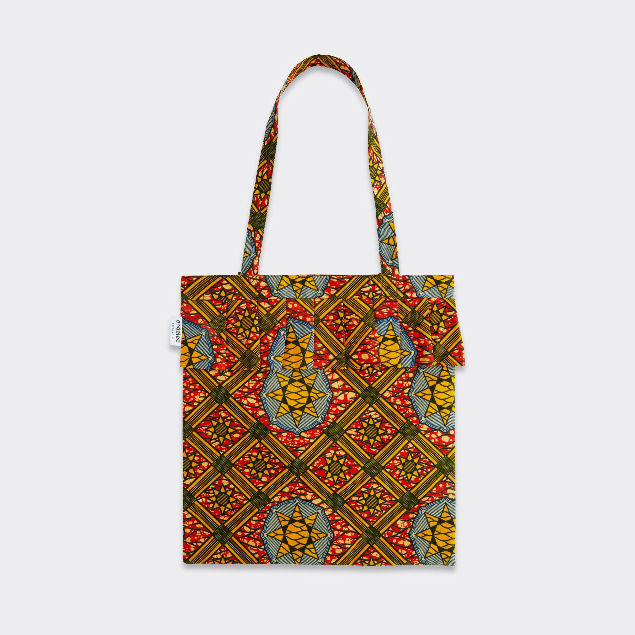 Still life: Tote Bag with Rouche in Wax Sun Labyrinth with colors yellow, red and blue.