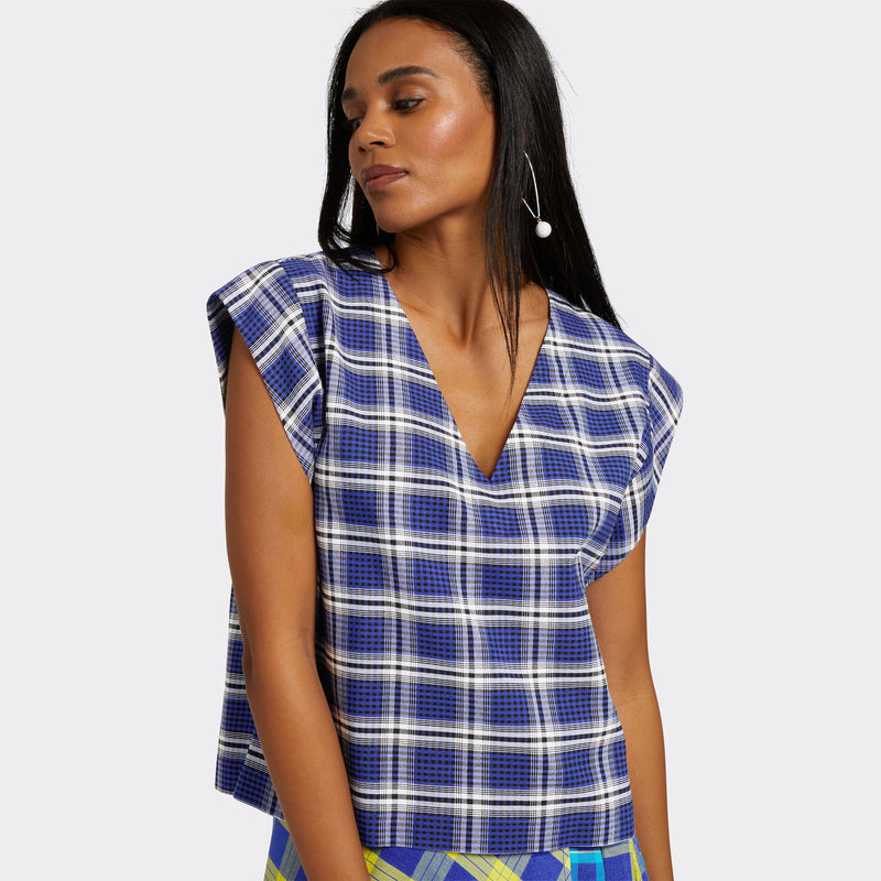 Model wears a V-Neck top with short sleeves. The print is Maasai Check in blue and white