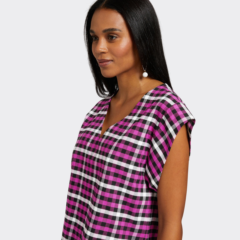 Model wears a V-Neck top with short sleeves. The print is Maasai Check in pink, black and white.