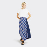 Model wears a Maasai Check wrap skirt in blue and white with a plain white tshirt.